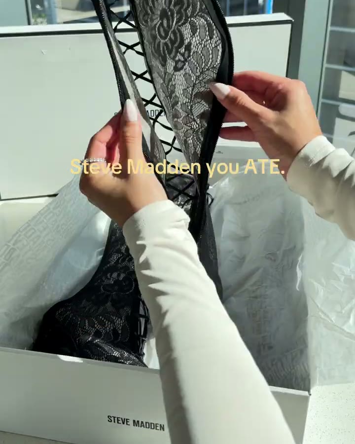 Holding the shaft open. The lace layer sits over the (Steve Madden Women's Maxine Black Lace Knee-High Boots, Aerely Chacón)