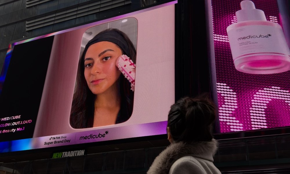 Aerely Chacón in Times Square under her Medicube TikTok Shop billboard